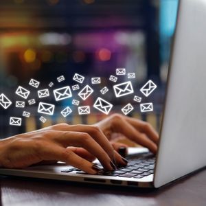 woman typing on laptop keyboard